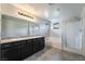 Bathroom boasts dual sinks, soaking tub, and glass shower enclosure with modern fixtures at 2332 Mundare Dr, Henderson, NV 89002