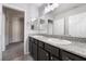 Double sink bathroom with granite countertop, dark wood cabinets, and tile flooring at 2332 Mundare Dr, Henderson, NV 89002