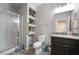Bathroom features a glass shower, a single sink vanity, and a decorative mirror at 2332 Mundare Dr, Henderson, NV 89002