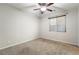 Bedroom features neutral walls, carpet, a ceiling fan, and natural light from the window at 2332 Mundare Dr, Henderson, NV 89002