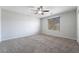 Neutral bedroom with a ceiling fan, one window with blinds and gray carpeting at 2332 Mundare Dr, Henderson, NV 89002