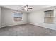Spacious bedroom with two windows, neutral carpeting, and base trim at 2332 Mundare Dr, Henderson, NV 89002