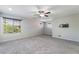 Large bonus room features neutral walls, carpet, a ceiling fan, and dual windows at 2332 Mundare Dr, Henderson, NV 89002