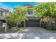 Two story home featuring a two-car garage and a neatly landscaped front yard at 2332 Mundare Dr, Henderson, NV 89002