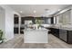 Well-lit kitchen with dark cabinetry, stainless steel appliances, and granite countertops at 2332 Mundare Dr, Henderson, NV 89002