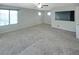 Spacious living area with plush carpet, large windows, and neutral paint at 2332 Mundare Dr, Henderson, NV 89002