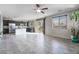 Open-concept living area featuring tile floors and access to the kitchen and backyard at 2332 Mundare Dr, Henderson, NV 89002
