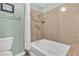 Bathroom featuring a tub with a shower and tiled walls at 2451 N Rainbow Blvd # 1066, Las Vegas, NV 89108