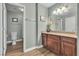 Well-lit bathroom featuring a single sink vanity with granite countertops and dark wood cabinets at 2451 N Rainbow Blvd # 1066, Las Vegas, NV 89108