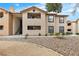 Exterior view of the multi-story home with a combination of stucco facade and a balcony in a well-maintained yard at 2451 N Rainbow Blvd # 1066, Las Vegas, NV 89108