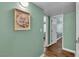 Hallway featuring a decorative 'Gathering' wall art and a view into a room at 2451 N Rainbow Blvd # 1066, Las Vegas, NV 89108