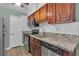 Stylish kitchen featuring modern appliances, granite countertops, and dark wood cabinets at 2451 N Rainbow Blvd # 1066, Las Vegas, NV 89108