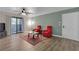 Inviting living room featuring wood flooring, a ceiling fan, access to a balcony, and contemporary decor at 2451 N Rainbow Blvd # 1066, Las Vegas, NV 89108