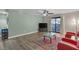 Bright living room with wood flooring, a ceiling fan, a sliding glass door, and modern furnishings at 2451 N Rainbow Blvd # 1066, Las Vegas, NV 89108