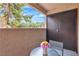 Inviting balcony space with a round table and chairs, providing a serene outdoor retreat at 2451 N Rainbow Blvd # 1066, Las Vegas, NV 89108