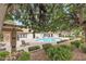 Community swimming pool featuring lounge chairs, mature landscaping, and inviting ambiance for relaxation and enjoyment at 2451 N Rainbow Blvd # 1066, Las Vegas, NV 89108