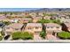Aerial view of tan two-story homes showcasing the neighborhood, landscaping, and private driveways at 2544 Sable Ridge St, Henderson, NV 89044