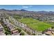 An elevated view of a community highlighting green fields, meticulously maintained landscaping, and picturesque mountain views at 2544 Sable Ridge St, Henderson, NV 89044