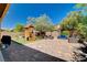 Landscaped backyard with patio, play structure, and seating areas, perfect for outdoor activities at 2544 Sable Ridge St, Henderson, NV 89044