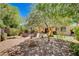 Secluded backyard with play area, patio furniture, and mature trees, creating a private retreat at 2544 Sable Ridge St, Henderson, NV 89044
