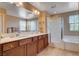 Bathroom featuring dual sinks with tile flooring, a shower and tub at 2544 Sable Ridge St, Henderson, NV 89044