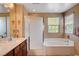 Bathroom with dual sinks, tiled floors, shower and soaking tub at 2544 Sable Ridge St, Henderson, NV 89044