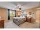 Well-lit bedroom featuring a ceiling fan, carpeted floor and large window at 2544 Sable Ridge St, Henderson, NV 89044