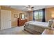 Comfortable bedroom with carpeted floors, ceiling fan, and window with bright sunlight at 2544 Sable Ridge St, Henderson, NV 89044