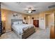 Well-lit bedroom with carpeted floors, neutral walls, ceiling fan and closet at 2544 Sable Ridge St, Henderson, NV 89044