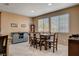 An intimate dining area features two windows, a gray serving buffet, and a wooden dining table at 2544 Sable Ridge St, Henderson, NV 89044