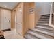 Inviting foyer with tiled floors and a carpeted staircase leading to the upper level at 2544 Sable Ridge St, Henderson, NV 89044