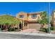 Two-story home showcasing an attached two-car garage, manicured landscaping, and covered front entryway at 2544 Sable Ridge St, Henderson, NV 89044