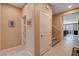 Hallway with neutral paint, carpeted stairs and tile floors at 2544 Sable Ridge St, Henderson, NV 89044