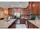 A modern kitchen features stainless steel appliances, a gray backsplash, and a large central island at 2544 Sable Ridge St, Henderson, NV 89044