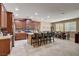 Spacious open kitchen with a center island, dark wood cabinets, stainless steel appliances, and adjacent dining area at 2544 Sable Ridge St, Henderson, NV 89044