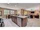 A kitchen island overlooks a dining area and living room with natural light at 2544 Sable Ridge St, Henderson, NV 89044