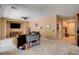 Open floor plan showcasing the living area, tile flooring, and access to the front door and kitchen at 2544 Sable Ridge St, Henderson, NV 89044