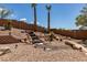 Backyard featuring a rock waterfall, desert landscaping, and plenty of privacy at 2587 Grizzly Park Ct, Henderson, NV 89052