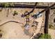 Aerial view of a private backyard with a small pond, waterfall, desert landscaping, and a dining area at 2587 Grizzly Park Ct, Henderson, NV 89052