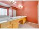 Bathroom featuring double sinks, large mirror, tiled flooring, and bright lighting at 2587 Grizzly Park Ct, Henderson, NV 89052