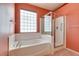 Bathroom featuring a tub, glass shower and tiled walls at 2587 Grizzly Park Ct, Henderson, NV 89052