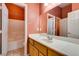 Bright bathroom featuring a tub/shower combo, white vanity, and neutral-toned flooring at 2587 Grizzly Park Ct, Henderson, NV 89052