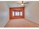 Bright, carpeted bedroom with a bay window and ceiling fan for added comfort at 2587 Grizzly Park Ct, Henderson, NV 89052
