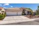 Attractive one-story home showcasing a spacious driveway and a two-car garage at 2587 Grizzly Park Ct, Henderson, NV 89052