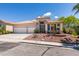Inviting single-story home with drought-tolerant landscaping and a spacious driveway leading to a two-car garage at 2587 Grizzly Park Ct, Henderson, NV 89052