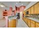 Spacious kitchen featuring wooden cabinetry, granite countertops, and modern appliances, perfect for cooking and entertaining at 2587 Grizzly Park Ct, Henderson, NV 89052