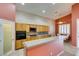 Open concept kitchen with spacious breakfast bar, modern appliances, wooden cabinets, and breakfast nook with natural light at 2587 Grizzly Park Ct, Henderson, NV 89052
