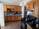 Functional kitchen featuring wood cabinets, a tile backsplash, and modern appliances for convenient meal preparation at 2725 Webster St, North Las Vegas, NV 89030