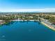 Stunning aerial view of a community and lake with a city skyline and mountains in the background at 2736 Huber Heights Dr, Las Vegas, NV 89128