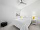 Bright bedroom with white walls and neutral carpet, furnished with a double bed, side tables, and a black ottoman at 2736 Huber Heights Dr, Las Vegas, NV 89128